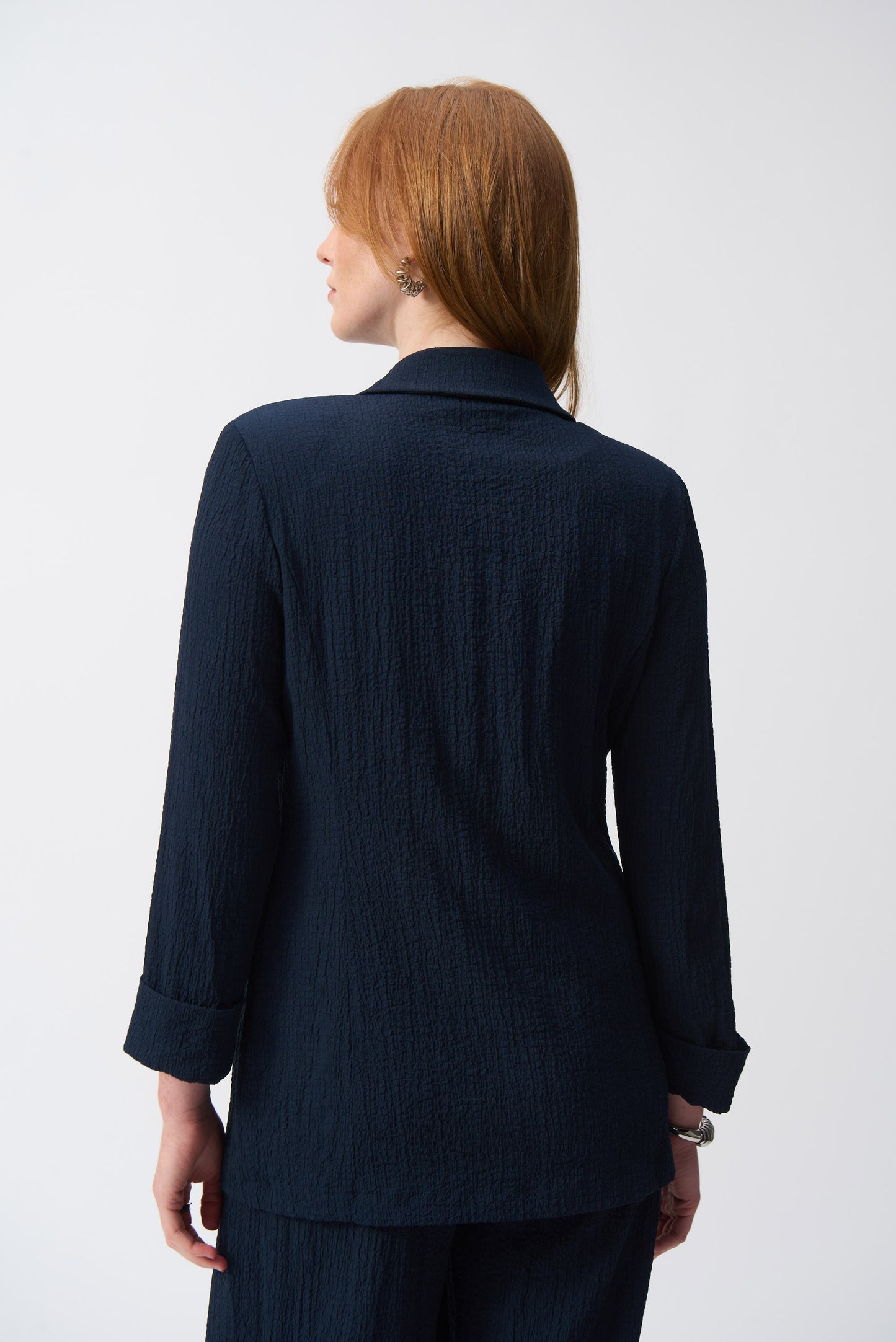 Hannahs Of Erin-Erin Ontario-Joseph Ribkoff-Textured Woven Blazer -Style 251082.colour midnight(navy) A tailored blazer with a refined textured fabric, notched collar, metallic single-button closure, and faux pocket flaps. Features three-quarter sleeves with folded cuffs and a straight silhouette. Available in the Spring 2025 Collection. Pair with matching trousers (Style 251293) for a polished look.