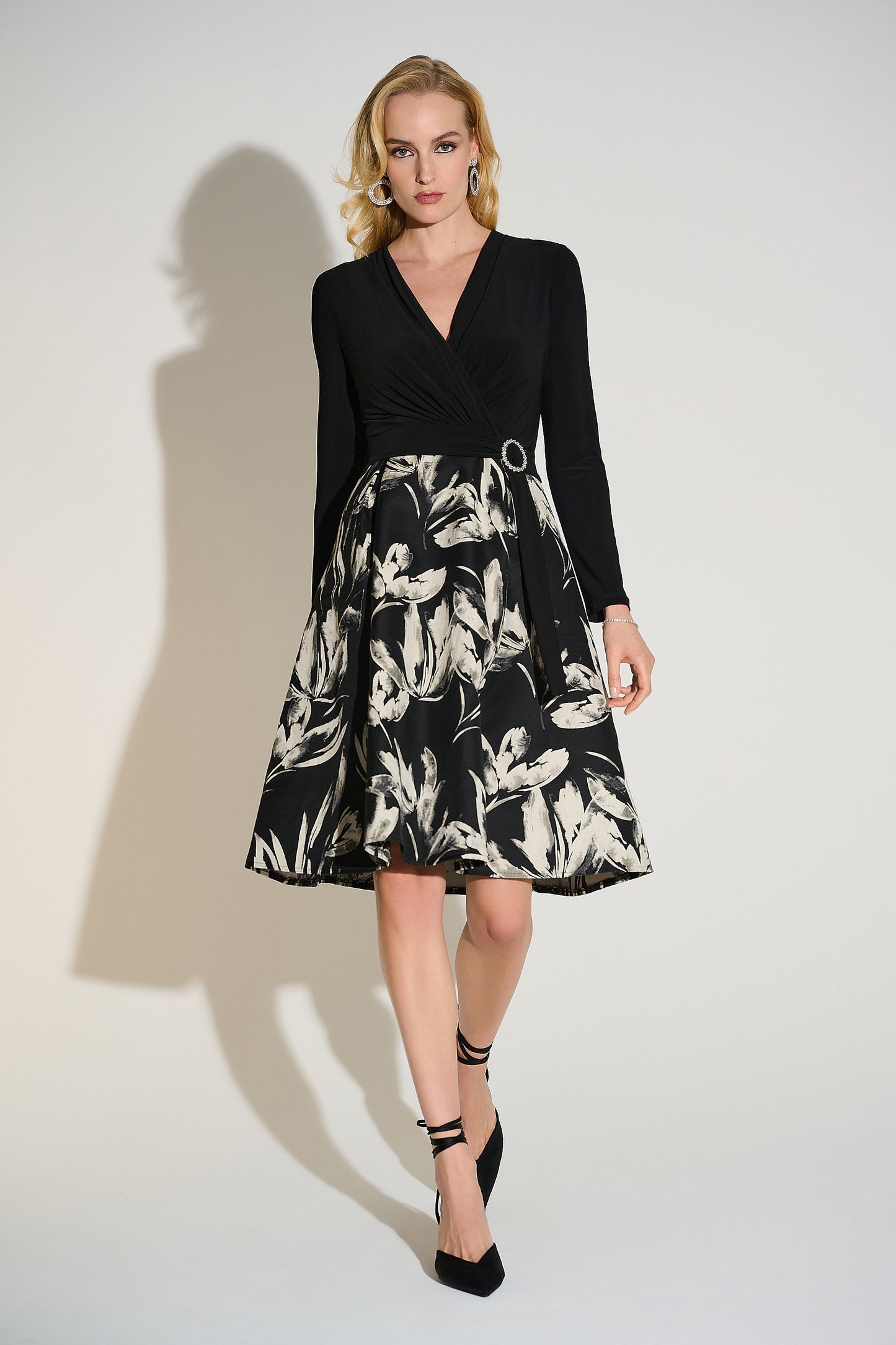 Hannahs Of Erin| Erin Ontario | Joseph Ribkoff | Signature | Silky Knit Jacquard Floral Fit and Flare Dress
colour black/white
75% Cotton, 25% Polyester
Silky knit, jacquard fabric
Floral print skirt
V-shape wrap neckline
Long straight sleeves
Self-tie waist sash with rhinestone buckle
Shirring detail at waist
Pleating at skirt
Unlined