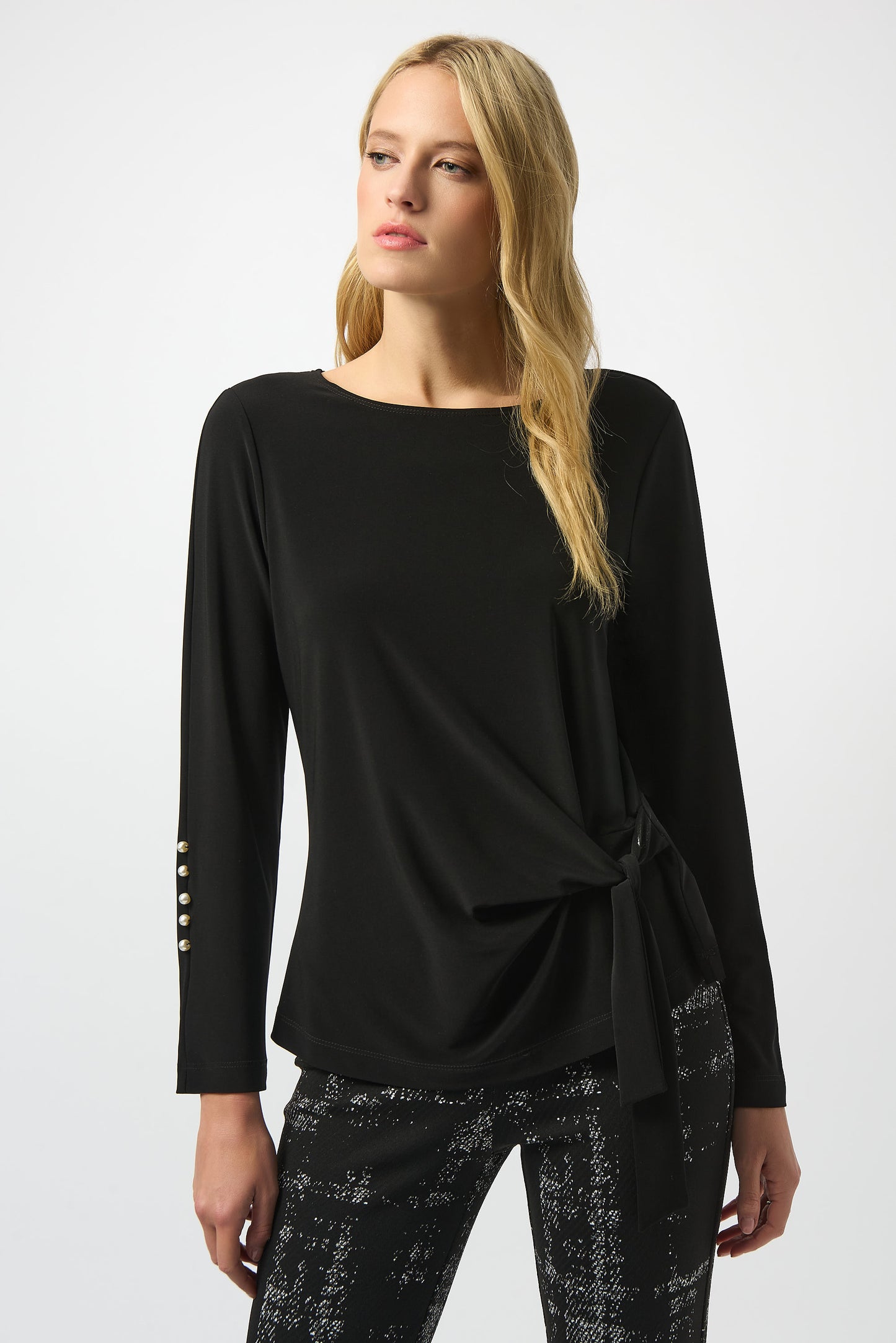 Hannahs Of Erin | Erin Ontario | Joseph Ribkoff | Silky Knit Fitted Top – Black
Joseph Ribkoff Silky Knit Fitted Top in black, tailored silhouette with chic boat neckline, long sleeves accented by pearl button detailing, and a side waist tie for a romantic finish. Crafted from silky knit fabric for a smooth, elegant drape.