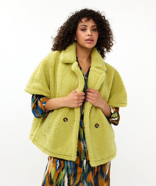 Hannahs Of Erin-Erin Ontario-Esqualo-Teddy Poncho Colour Leaf Green (lime green) unique teddy poncho with stitching detail, 2 buttons and slits on both sides.

Knotch lapel style collar;

Double breasted;

Pockets;

100% Polyester / Lining: 100% Polyester

Leaf Green
Short sleeve.