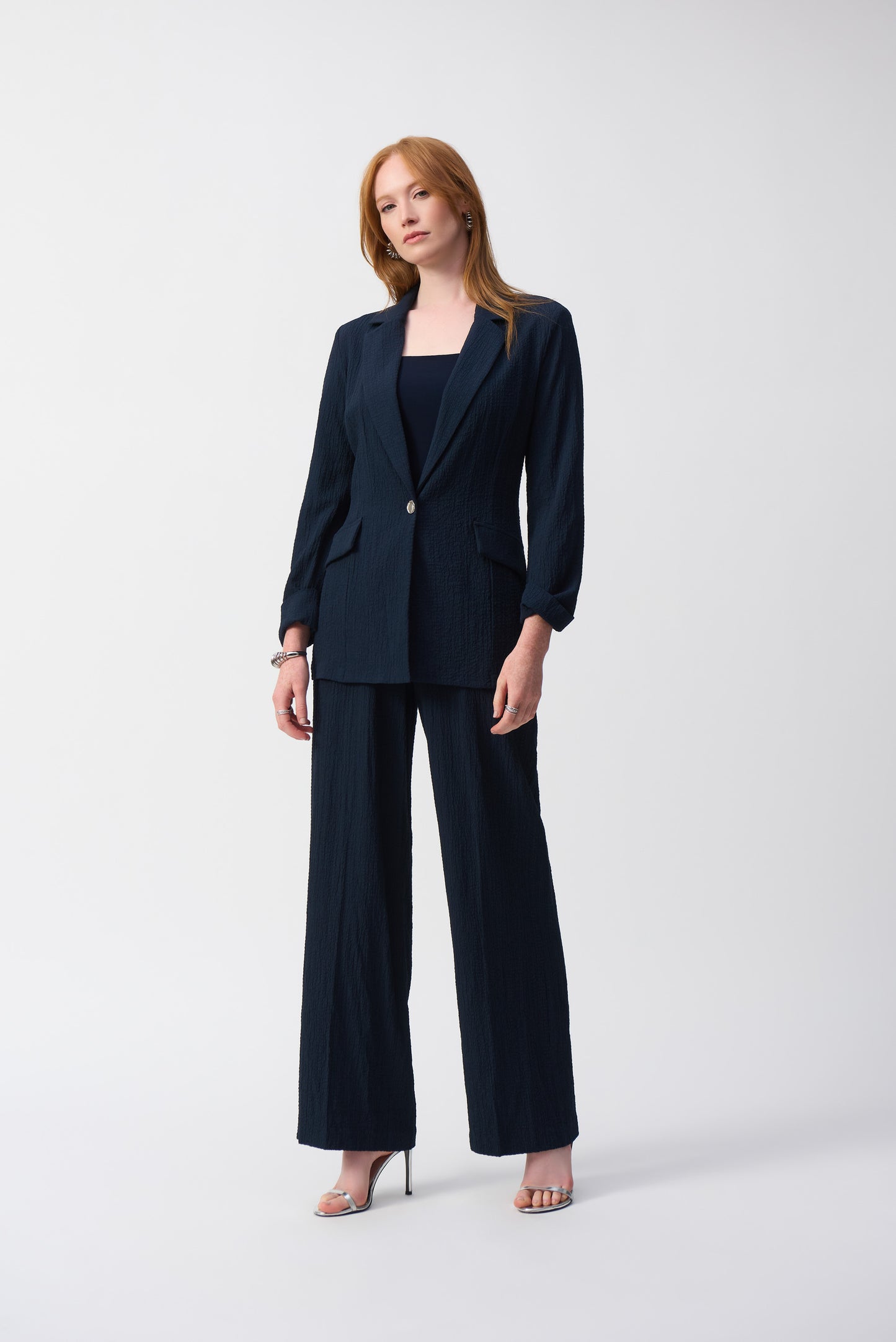 Hannahs Of Erin-Erin Ontario-Joseph Ribkoff-Textured Woven Blazer -Style 251082.colour midnight(navy) A tailored blazer with a refined textured fabric, notched collar, metallic single-button closure, and faux pocket flaps. Features three-quarter sleeves with folded cuffs and a straight silhouette. Available in the Spring 2025 Collection. Pair with matching trousers (Style 251293) for a polished look.







