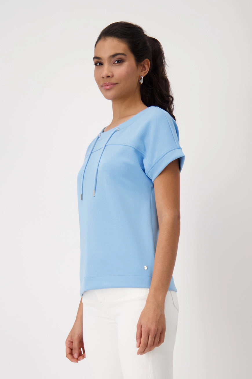 
Hannahs_Of_Erin-Erin_Ontatio-Monari-S_S_BANU_SWEAT_SHIRT-Sky Blue. Monari soft-touch sweatshirt in stretch modal blend, featuring a stand-up collar with metal grommet drawstring, short dropped sleeves, and a relaxed silhouette