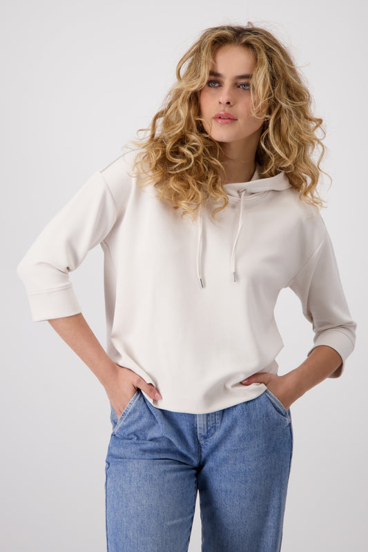 Hannahs_Of_Erin-_Erin_Ontario-Monari-3_4_SLEEVE-_BANU_HOODIE-409334-cement-Hannahs Of Erin- Erin Ontario-Monari-3/4 SLEEVE- BANU HOODIE-409334.
women's hooded sweatshirt in soft off-cement coloured modal blend, featuring delicate silver chain detail along the shoulders, ¾-length dropped sleeves, ribbed cuffs and hem, and a drawstring hood with metallic grommets