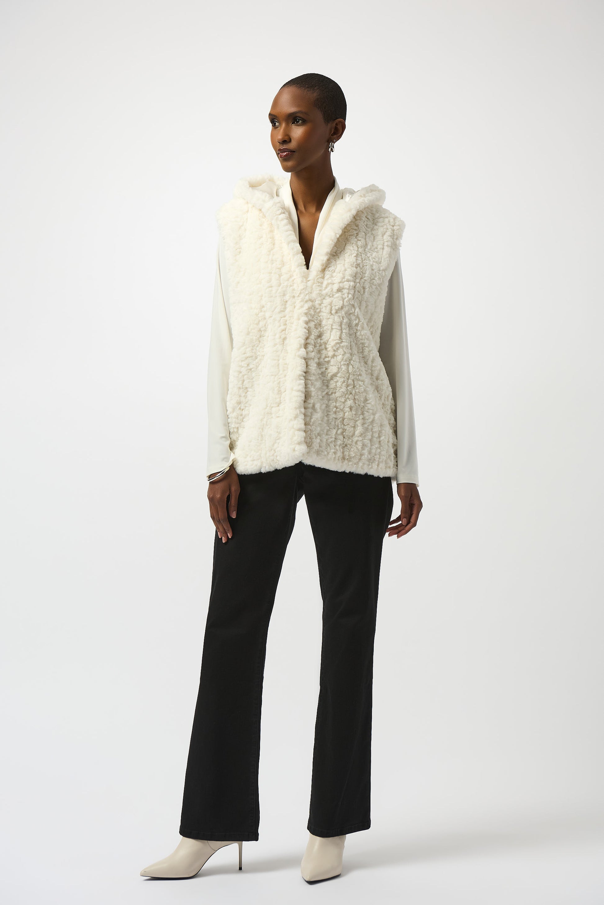 Hannahs Of Erin| Erin Ontario | Joseph Ribkoff | Faux Fur Textured Stripe Vest| colour Vanilla. Joseph Ribkoff sleeveless faux fur vest with textured stripe pattern, hooded collar, discreet hook-and-eye closure, and full lining, offering plush warmth and sophisticated layering.