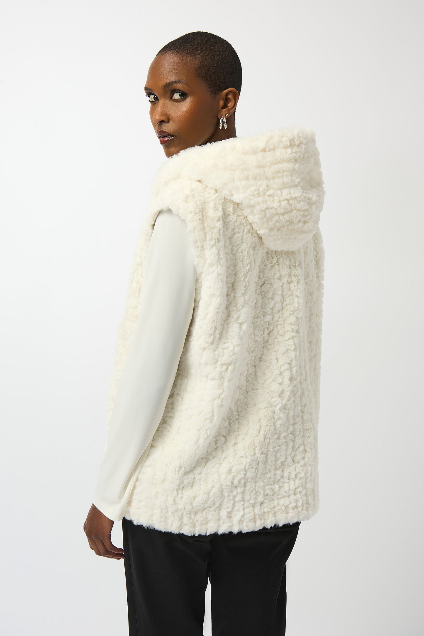 Hannahs Of Erin| Erin Ontario | Joseph Ribkoff | Faux Fur Textured Stripe Vest| colour Vanilla. Joseph Ribkoff sleeveless faux fur vest with textured stripe pattern, hooded collar, discreet hook-and-eye closure, and full lining, offering plush warmth and sophisticated layering.