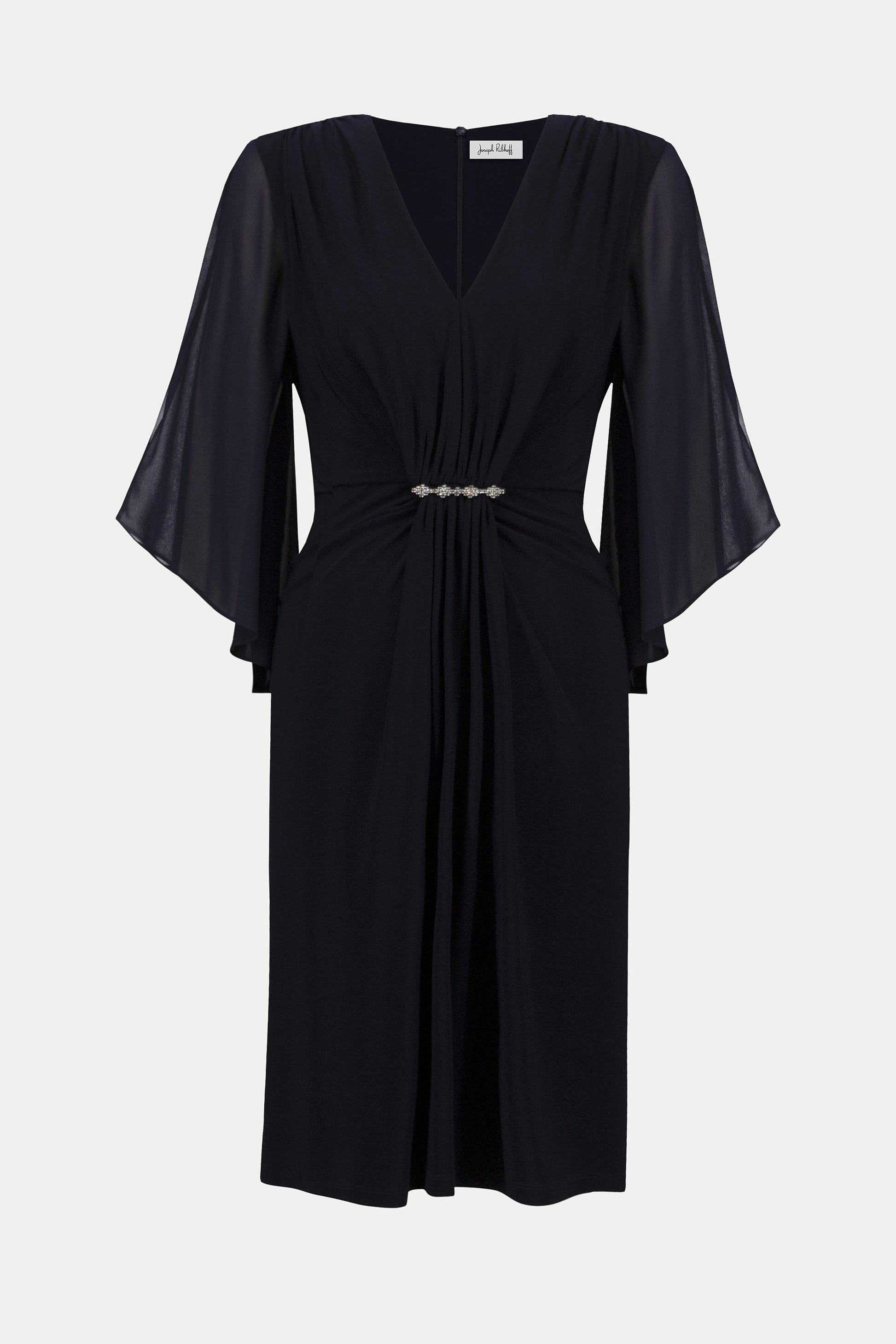 Hannahs Of Erin| Erin Ontario|Joseph Ribkoff Signature silky knit and chiffon sheath dress in midnight blue, featuring a V-neckline, three-quarter chiffon bell sleeves, delicate front draping, and a rhinestone ornament at the waist. Falls just below the knee and fully lined for a smooth, elegant fit, ideal for special occasions.
