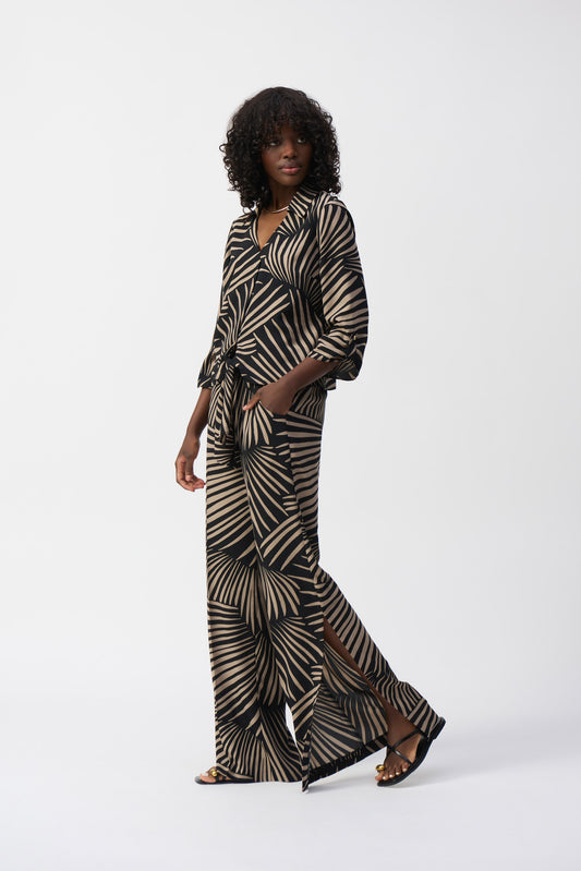 Hannahs of Erin-Erin Ontario-
Joseph Ribkoff Printed Tie-Front Blouse (Style 251083):

Bold abstract  Black and camel coloured "palm" print for a modern, sophisticated look
Classic shirt collar for a polished touch
Adjustable front-tie detail for a flattering waistline, 3/4 length sleeve.
Lightweight, breathable 100% polyester fabric
Relaxed yet structured fit, suitable for all body types
Made in Canada with premium craftsmanship
Versatile styling: pair with trousers, jeans, or a pencil skirt